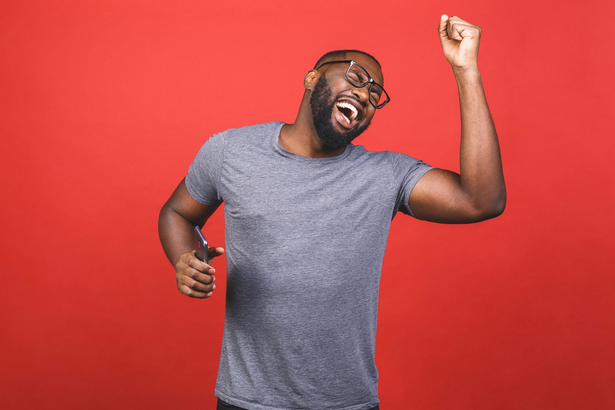 Indoor,Portrait,Of,Young,Handsome,African,Man,Isolated,On,Red picture of man singing